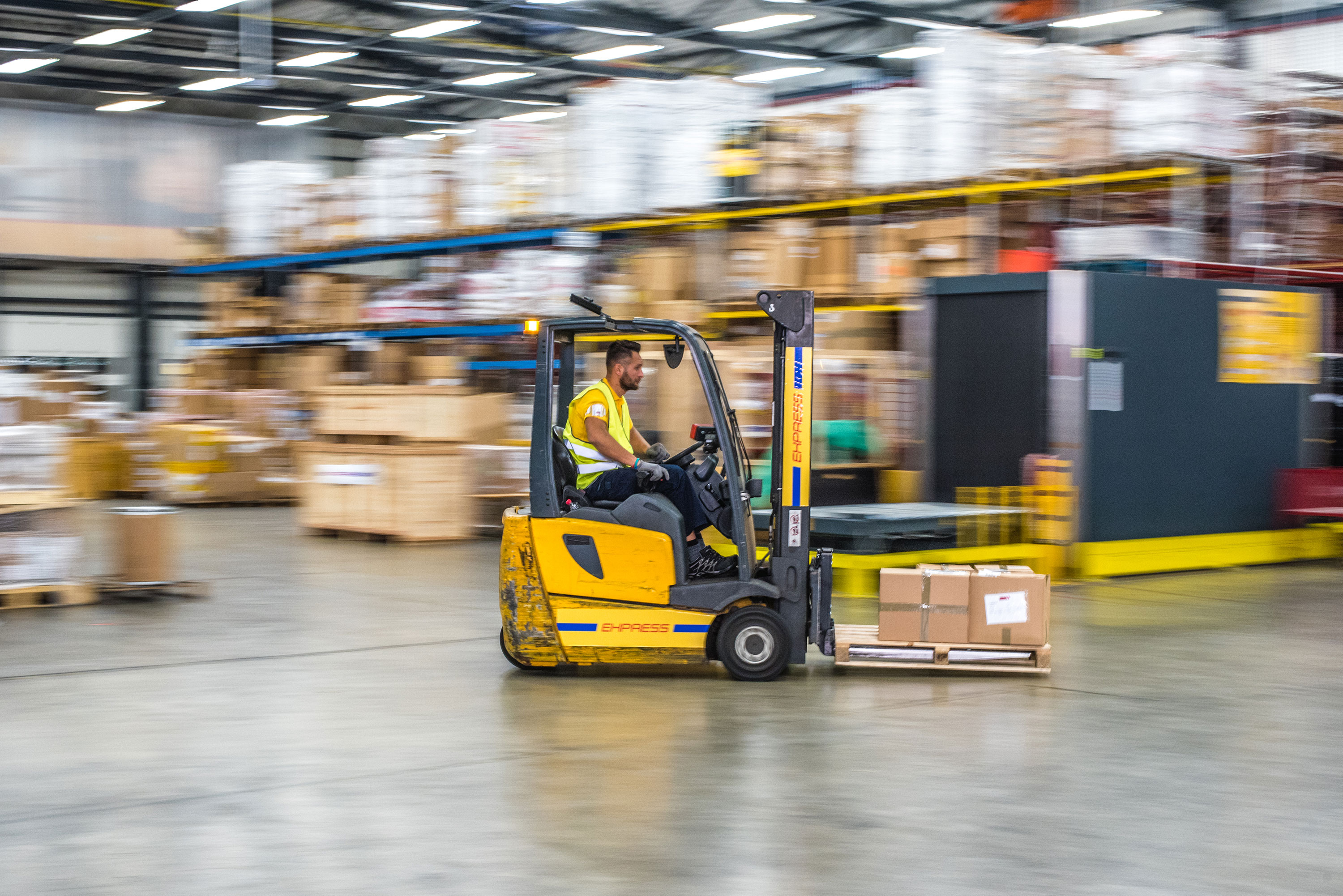 Warehouse employee on a forklift Warehouse employee on a forklift