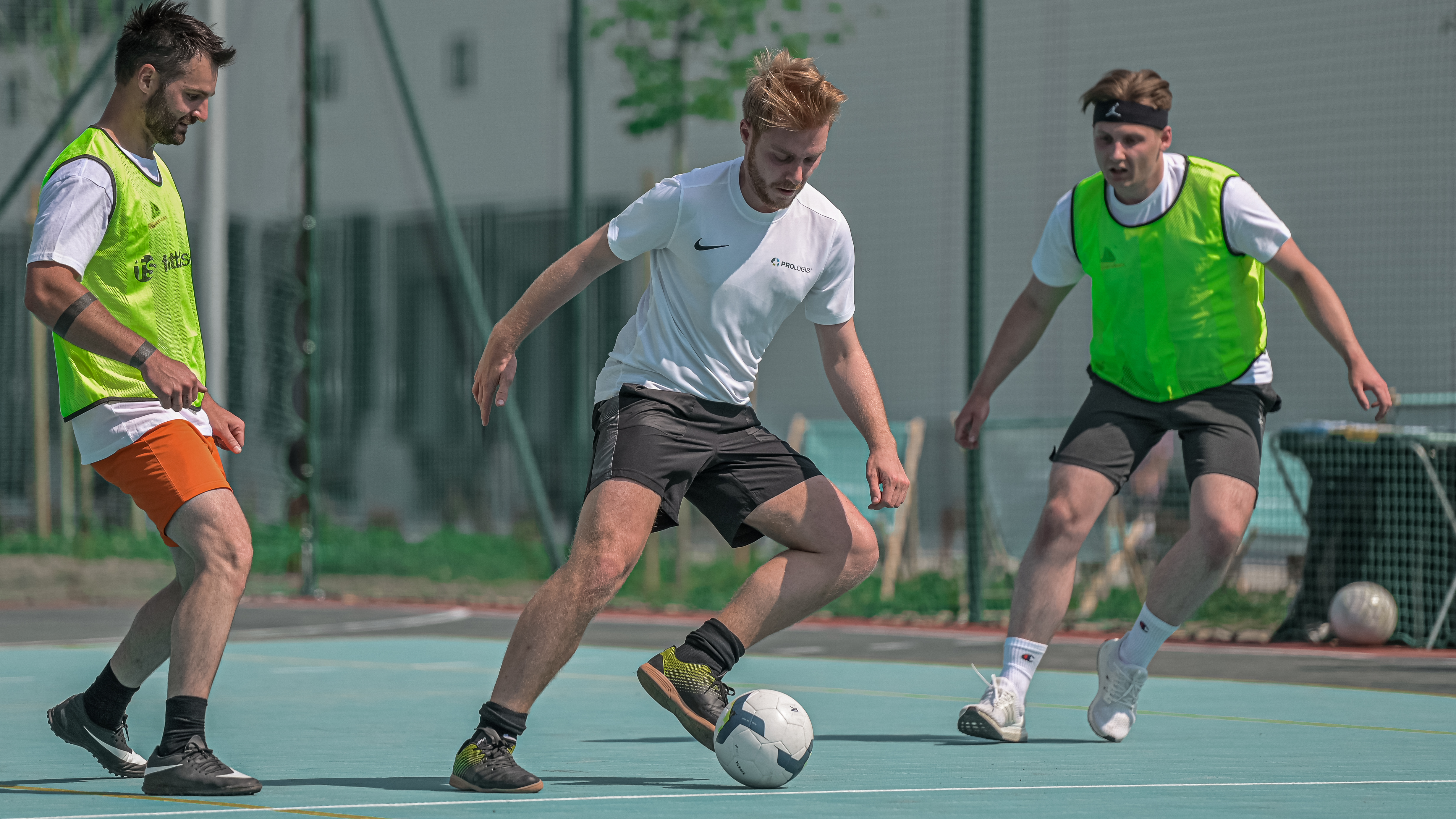 Football tournament at Prologis Park Łódź Three football players on the field