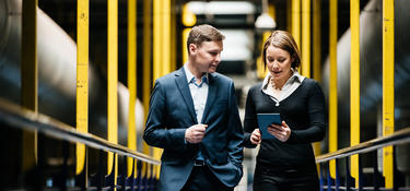 Two people walking in a warehouse