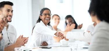 Office workers, with two people shaking hands