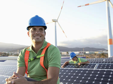 Two people working on solar panels