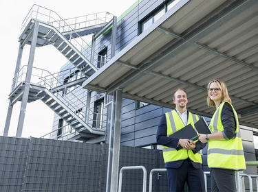 Two property managers stand outside a Prologis warehouse