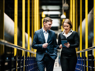 Two people walking in a warehouse