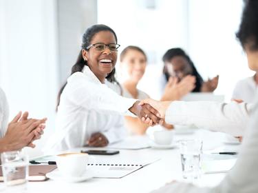 Office workers, with two people shaking hands