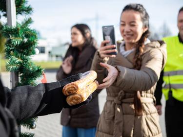 Girl with a phone receiving holiday pastries