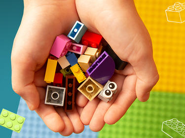 graphics with kids hand full of colorful bricks