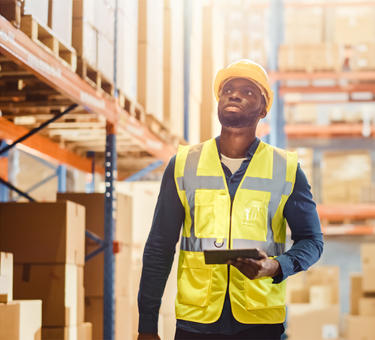 A man in a warehouse checking inventory 