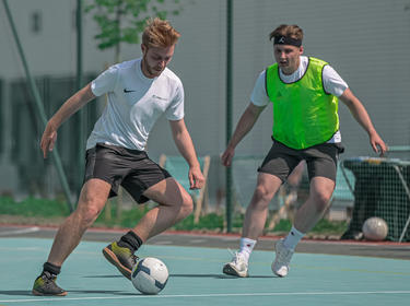 Three football players on the field